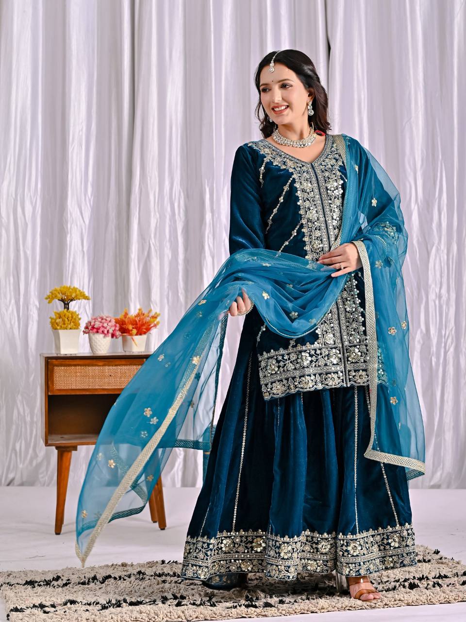 Elegance in Deep Blue Velvet Attire